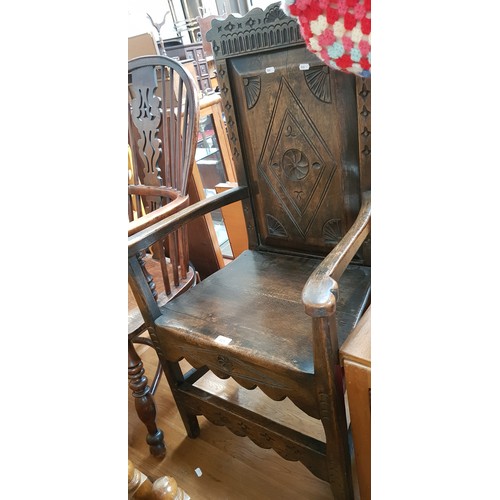 921 - A 17th century style oak armchair.