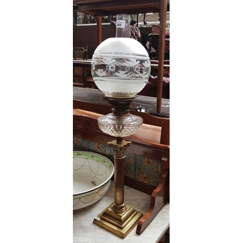 948 - A brass and glass oil lamp with Corinthian column base.