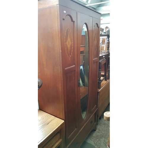 943 - An Edwardian inlaid mahogany wardrobe.