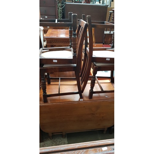 944 - A walnut drop leaf table and four 1930s oak chairs.