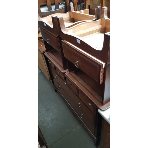 945 - A stag mahogany chest of drawers and two matching bedside cabinets