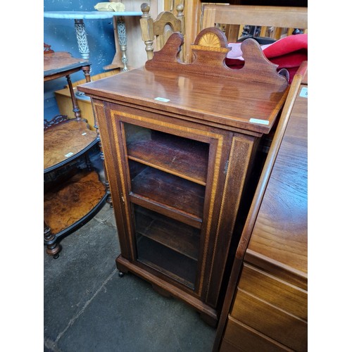 998 - An Edwardian inlaid mahogany music cabinet.