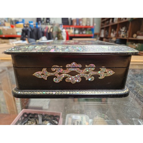 28 - A Victorian black lacquer and mother of pearl inlaid jewellery box with quilted interior and contain... 