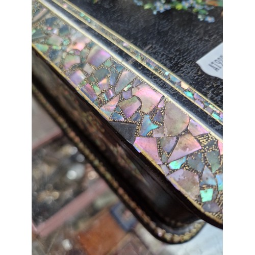 28 - A Victorian black lacquer and mother of pearl inlaid jewellery box with quilted interior and contain... 