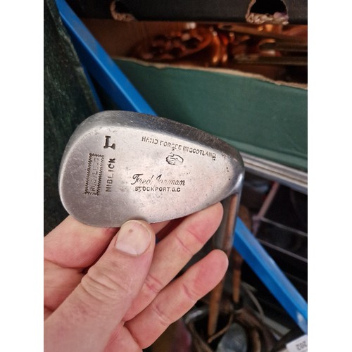 202 - A vintage leather golf back with five hickory shafted clubs.