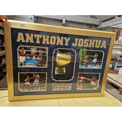 131 - An Anthony Joshua signed glove and light up picture display.