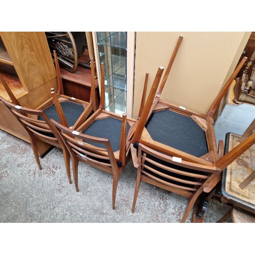 1021 - A set of six mid 20th century teak dining chairs including two carvers.