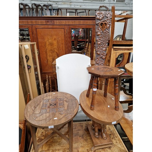 1022 - A mixed lot comprising African carved wood tables, a carved oak spinning chair and a carved hardwood... 