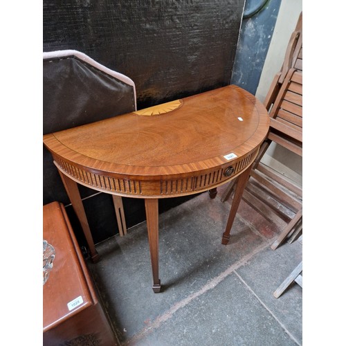 1027 - An Adam style inlaid mahogany demi lune table.