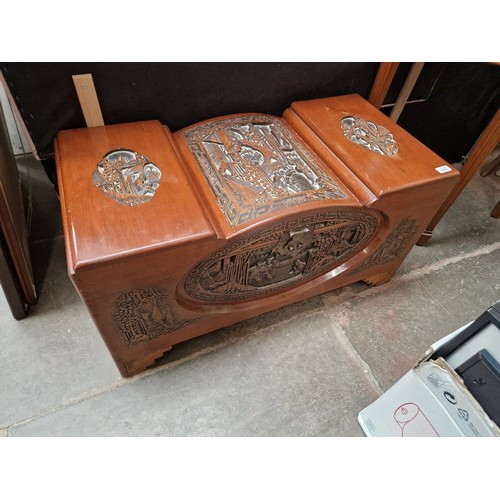 1028 - An Eastern carved camphor wood chest.