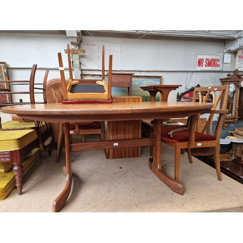 1033 - A mid 20th century G Plan teak extending dining table and four chairs.