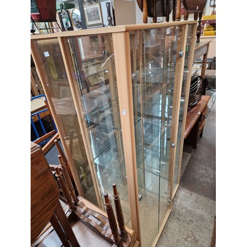 1018 - Three glass display cabinets with interior lights.