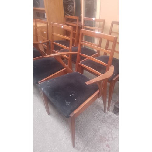 1021 - A set of six mid 20th century teak dining chairs including two carvers.