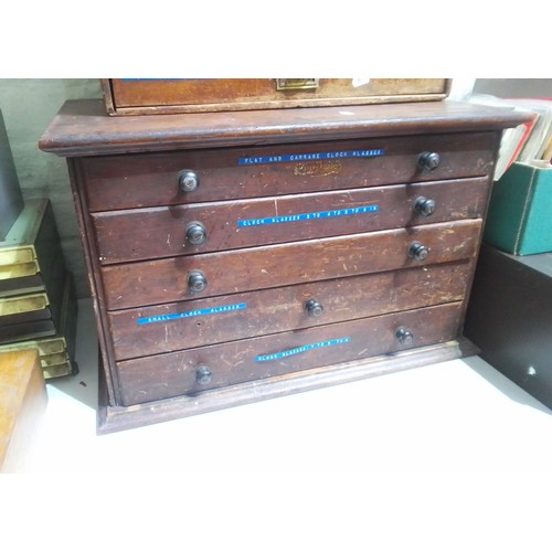 74 - A horologist's five drawer chest and contents comprising watch and clock making spares.