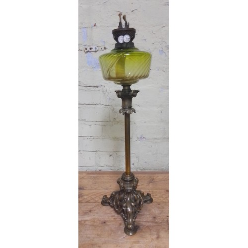 112 - A cast brass oil lamp with green glass reservoir.