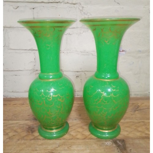 122 - A pair of French 19th century opaline green and gilt glass baluster vases with flared rims, ovoid bo... 