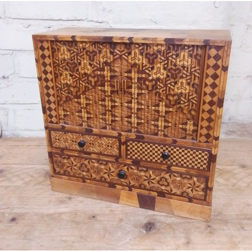 97 - A Japanese parquetry inlaid miniautre cabinet.