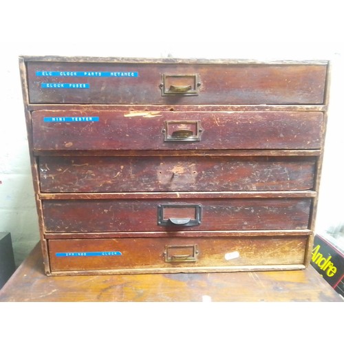 73 - A five drawer horologist's chest and contents comprising watch and clock making spares.