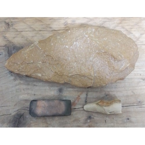 143 - Neolithic stone tools comprising a large axe head, length 22cm, a small polished rectangular scraper... 