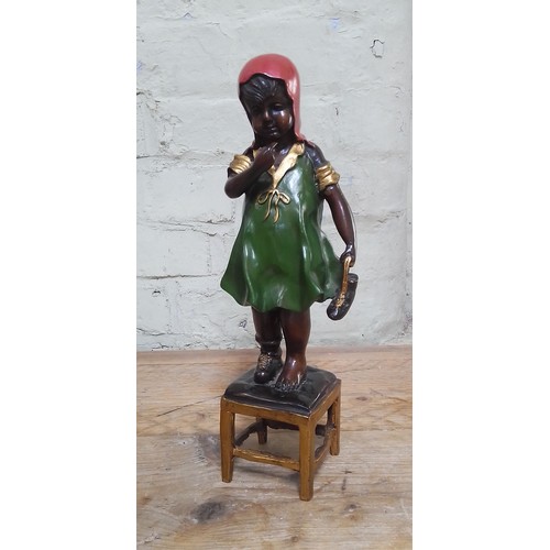 129 - A cold painted bronze modelled as a young girl, height 36.5cm.