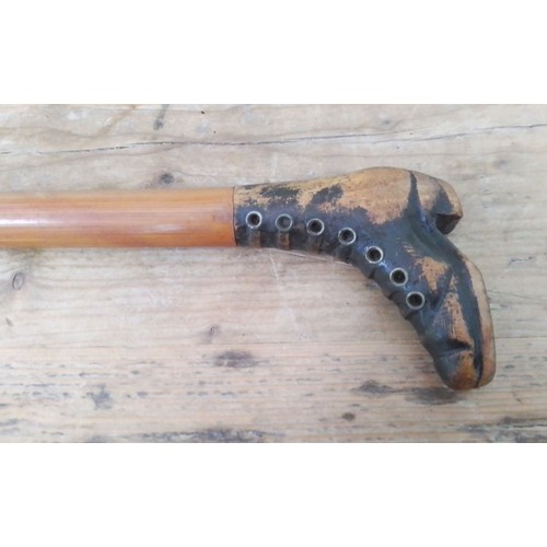 199 - An antique walking stick, the handle modelled as a boot with brass eyelets, length 87cm.