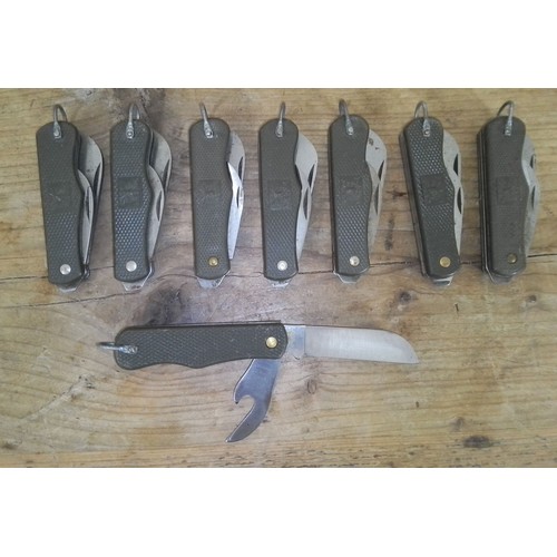 165 - A group of eight Italian army penknives with eight knife pouches.