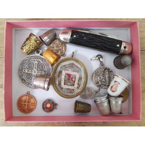 179 - A brass framed collection of religious relics 5.5cm x 5cm, together with other collectables.