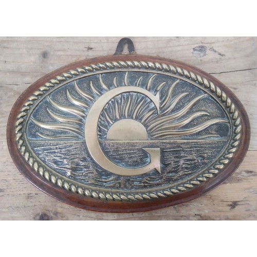 135 - A maritime brass plaque and oak board, length 26cm.