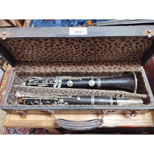 202 - A rosewood clarinet marked 'France' and 'New Brunswick'.