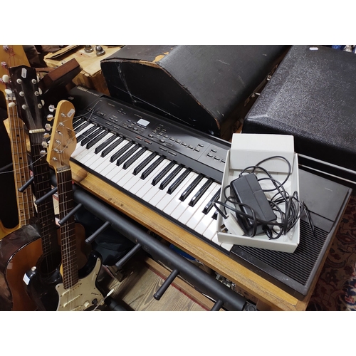 211 - An Encore black electric guitar together with a Viva acoustic guitar, a Yamaha PSR-50 keyboard and a... 