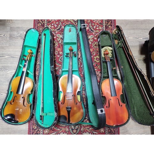 212 - Three Chinese Skylark student violins, each with bow and hard case.