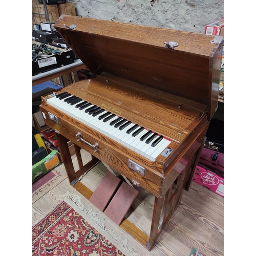 231 - A Pearl River portable organ/harmonium in oak case, width 79cm.