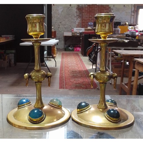 290 - A pair of Gothic style copper and brass candlesticks set with hard stone cabochons, height 17cm.