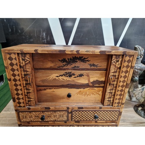 97 - A Japanese parquetry inlaid miniautre cabinet.