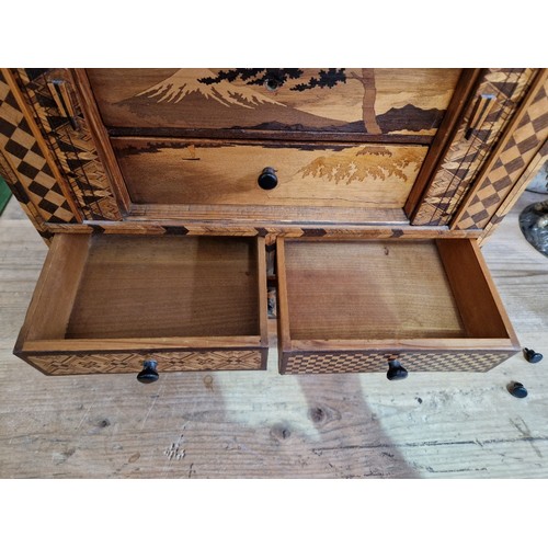 97 - A Japanese parquetry inlaid miniautre cabinet.