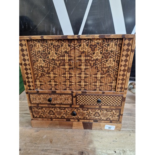 97 - A Japanese parquetry inlaid miniautre cabinet.