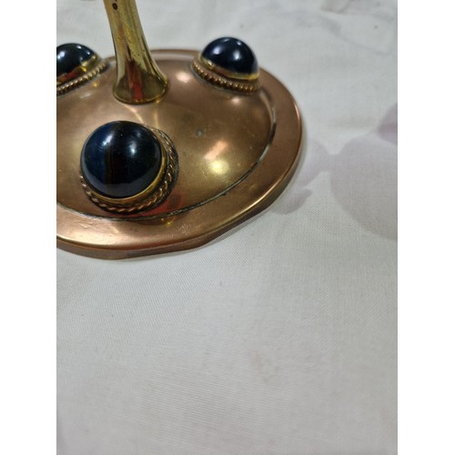 290 - A pair of Gothic style copper and brass candlesticks set with hard stone cabochons, height 17cm.