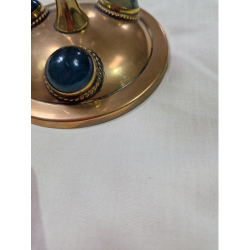 290 - A pair of Gothic style copper and brass candlesticks set with hard stone cabochons, height 17cm.