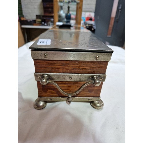 103 - A silver plated oak tea caddy, circa 1900, the tope engraved with butterflies and acorns.