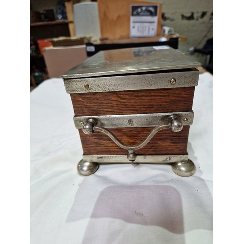 103 - A silver plated oak tea caddy, circa 1900, the tope engraved with butterflies and acorns.