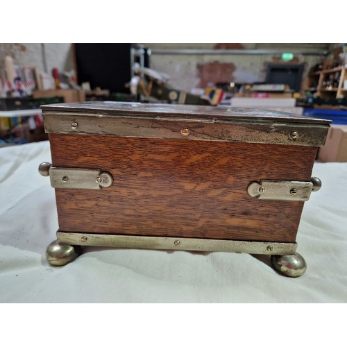 103 - A silver plated oak tea caddy, circa 1900, the tope engraved with butterflies and acorns.