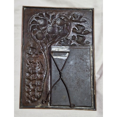 291A - An Arts & Crafts copper picture frame decorated with birds, fruit tree and flowers.