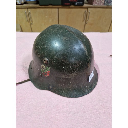 175 - A WWII Bulgarian helmet and three others.