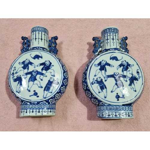 124 - A pair of Chinese late 19th century blue and white porcelain moonflasks decorated with figures, unma... 