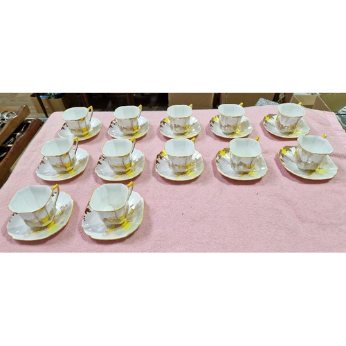 495 - A Shelley Sunrise and Tall Trees Art Deco tea service, 40 pieces.