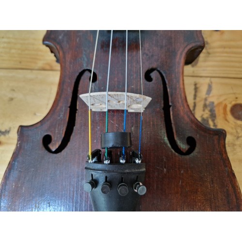 201 - A German 19th century violin, one piece back, length 355mm, with bow stamped Homa, in hard case.