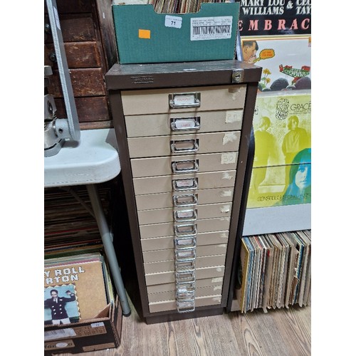 74A - A 15 drawer triumph metal cabinet and contents comprising of clock making spares.