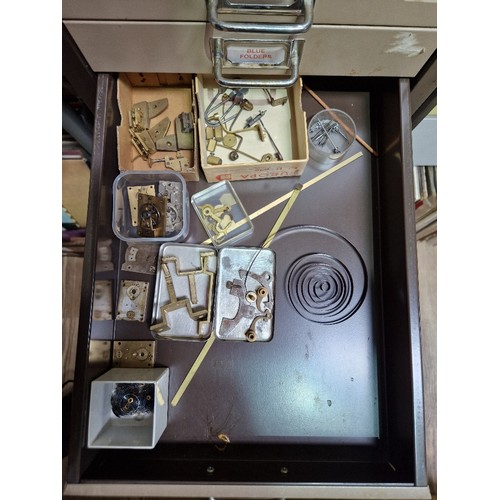 74A - A 15 drawer triumph metal cabinet and contents comprising of clock making spares.