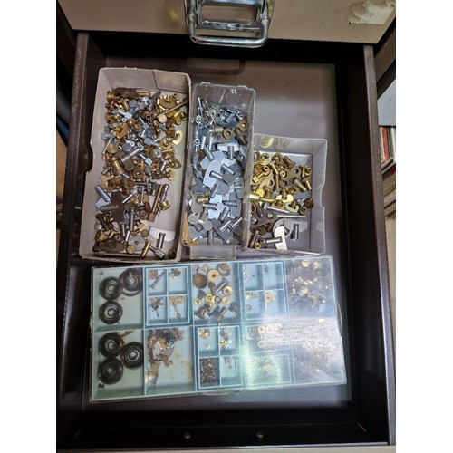 74A - A 15 drawer triumph metal cabinet and contents comprising of clock making spares.