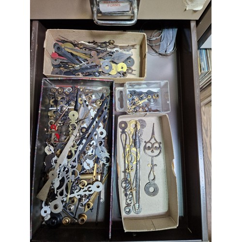 74A - A 15 drawer triumph metal cabinet and contents comprising of clock making spares.